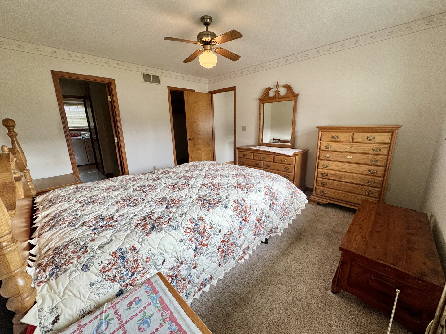 31 Colonial Drive Clinton, IL 61727 - Photo 14 of 24 a bedroom with a bed and a chandelier