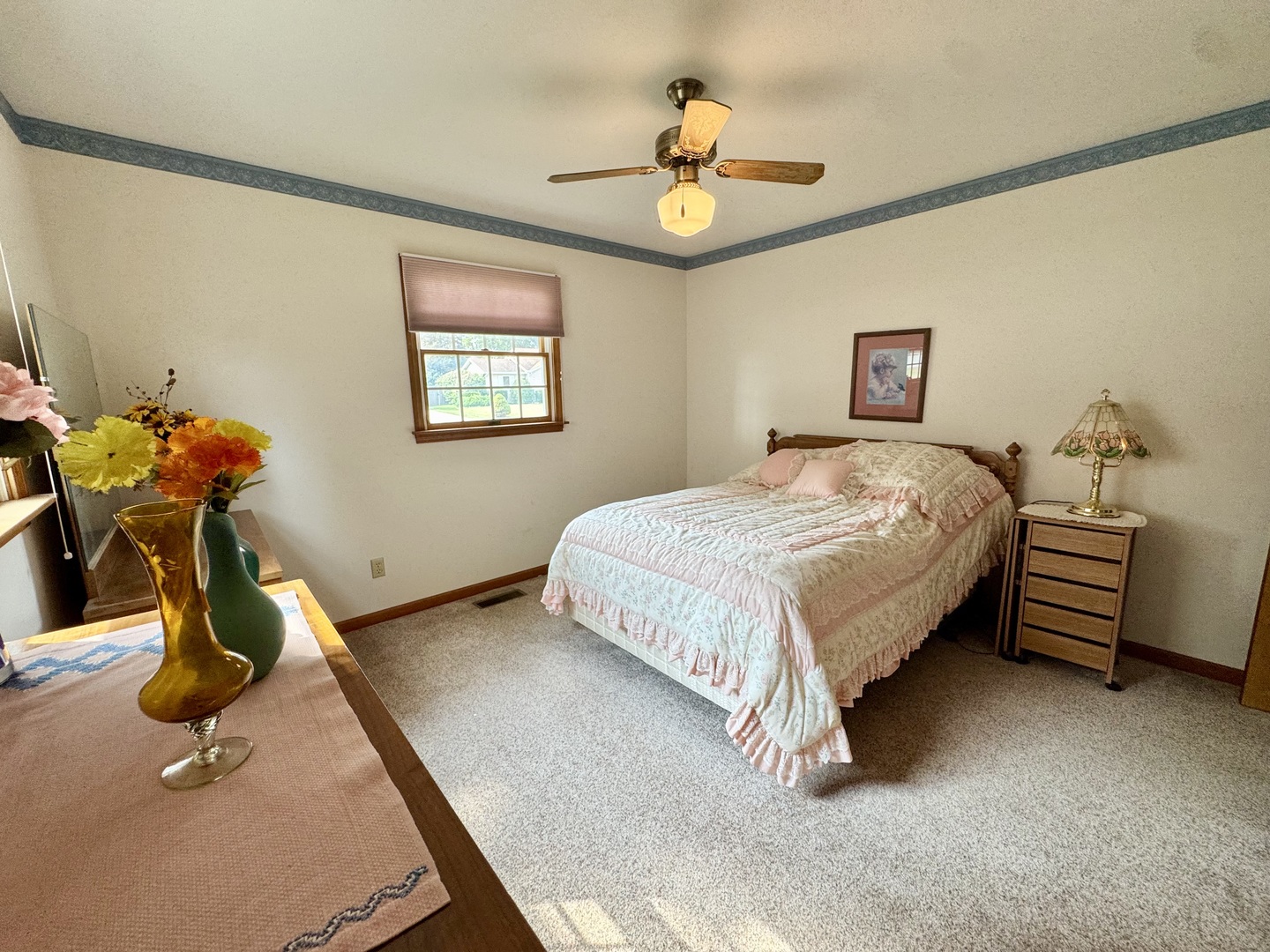 31 Colonial Drive Clinton, IL 61727 - Photo 20 of 24 a bedroom with a bed and a chandelier