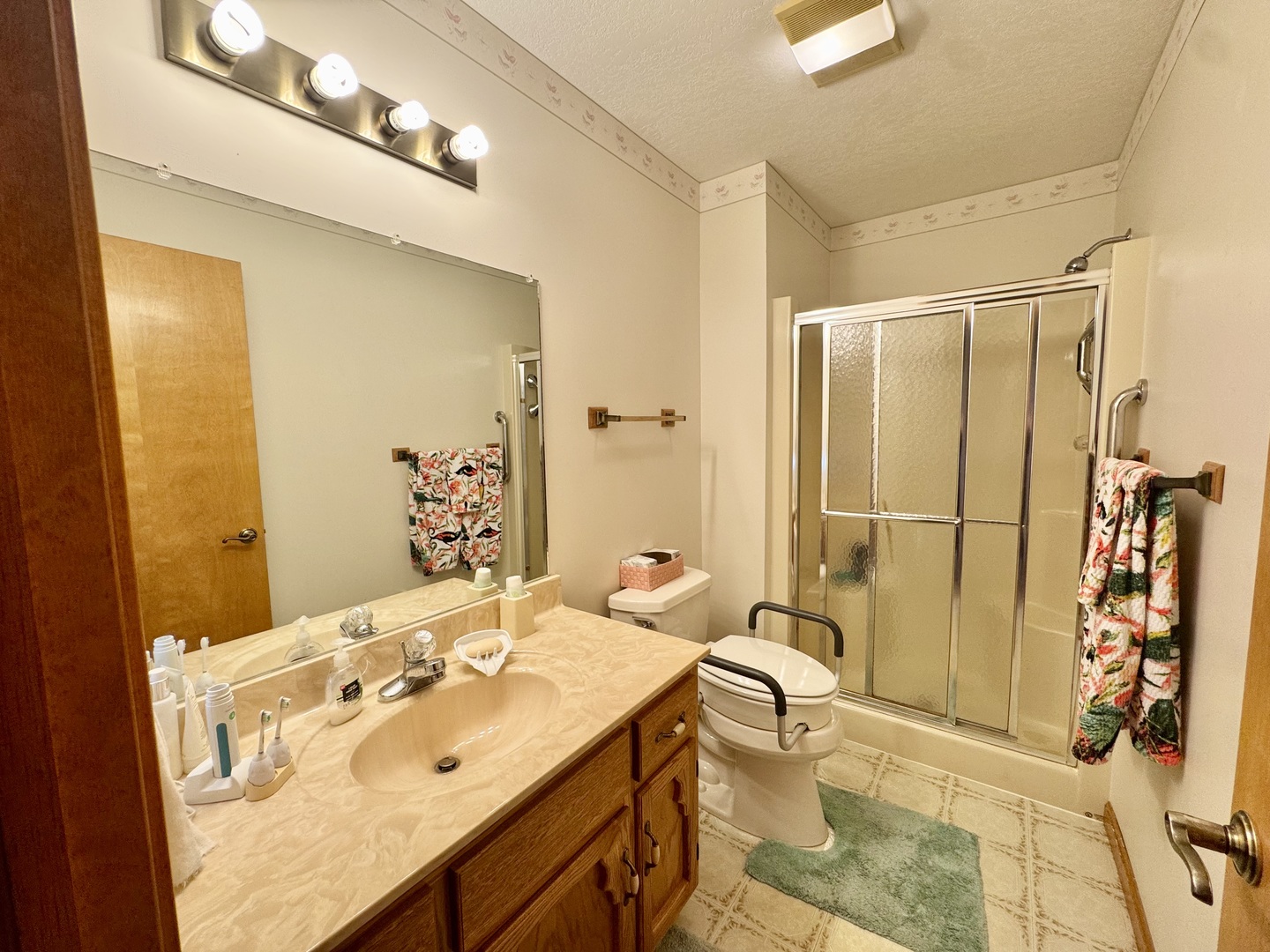 31 Colonial Drive Clinton, IL 61727 - Photo 22 of 24 a en suite bathroom with a granite countertop sink and a mirror