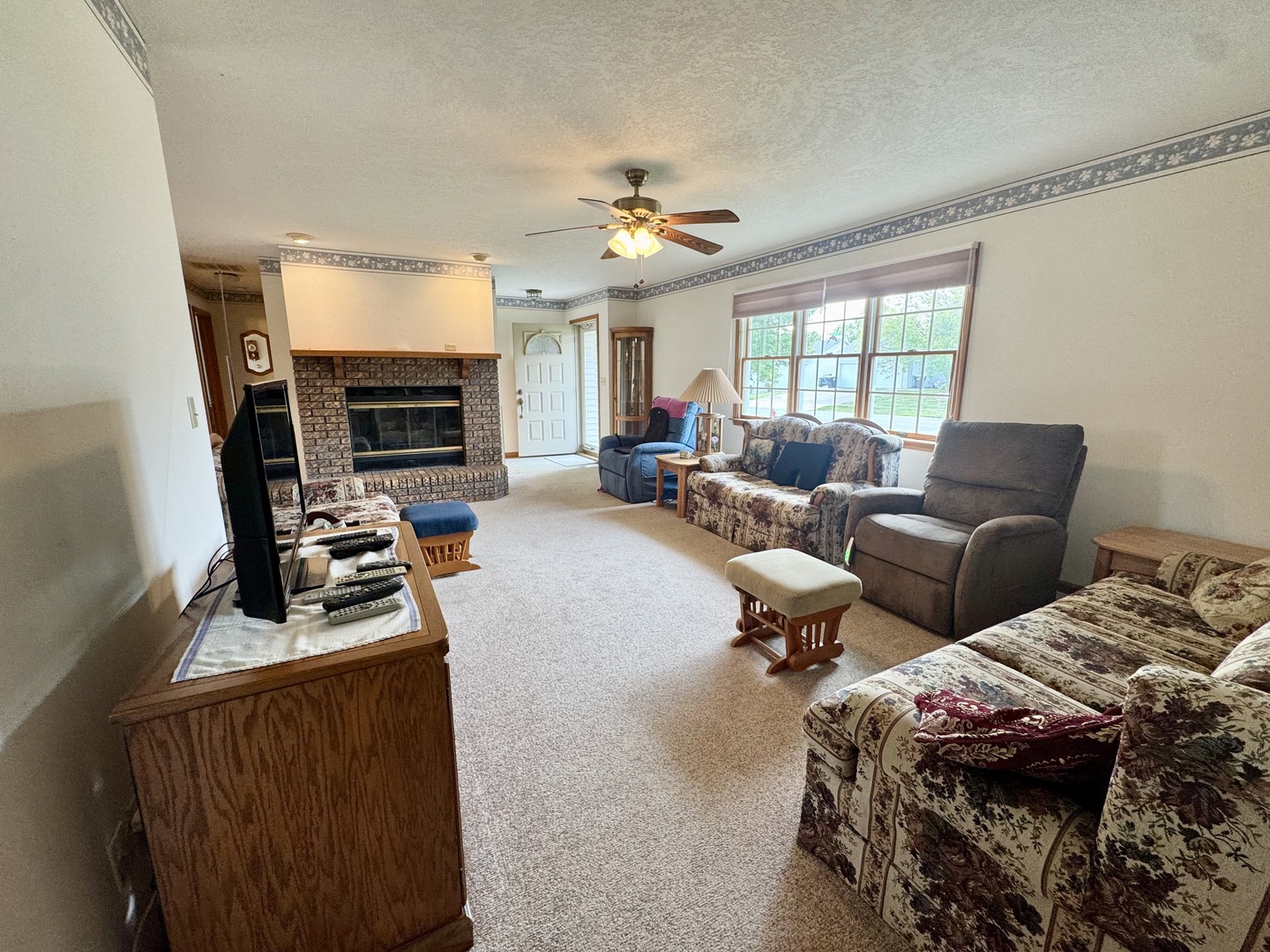 31 Colonial Drive Clinton, IL 61727 - Photo 6 of 24 a bedroom with furniture and a fireplace