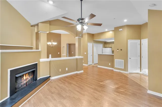 a view of an empty room and kitchen view