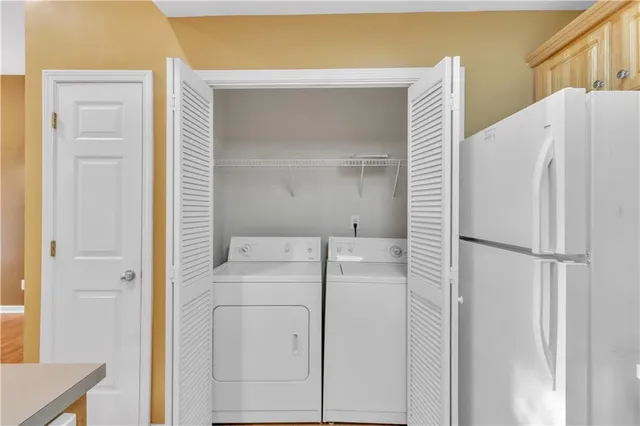 a white refrigerator freezer and a wooden floor