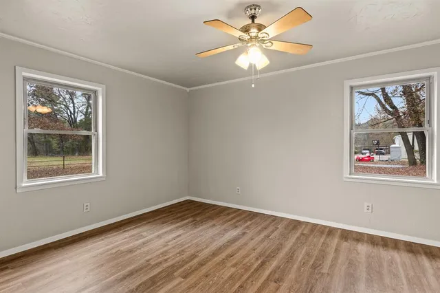 wooden floor in an empty room with a window