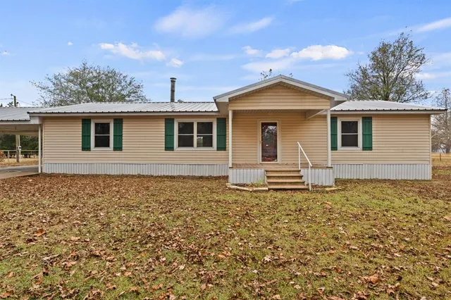 front view of a house with a yard