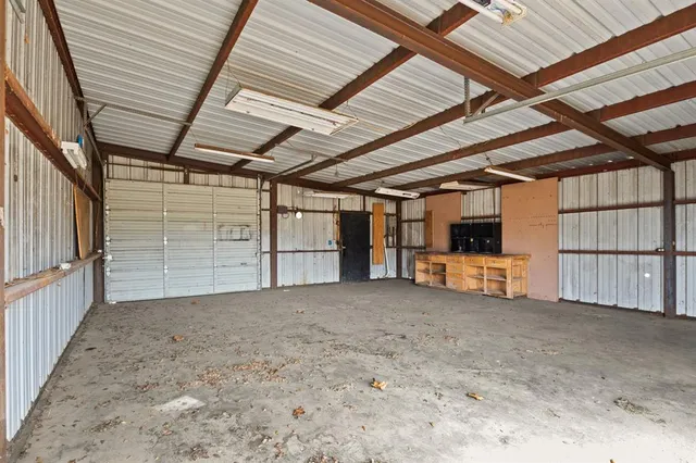 a view of empty room with wooden ceiling