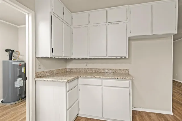 a view of a kitchen with white cabinets