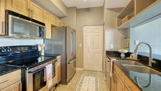 a kitchen with granite countertop a stove and a sink