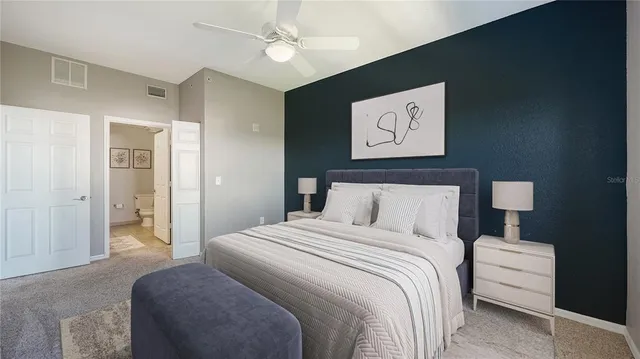 a bedroom with a bed and a painting on the wall