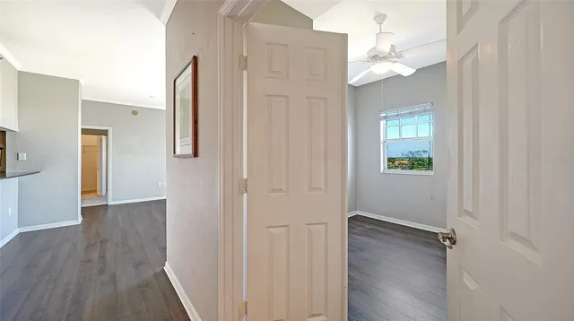 a view of a hallway with wooden floor