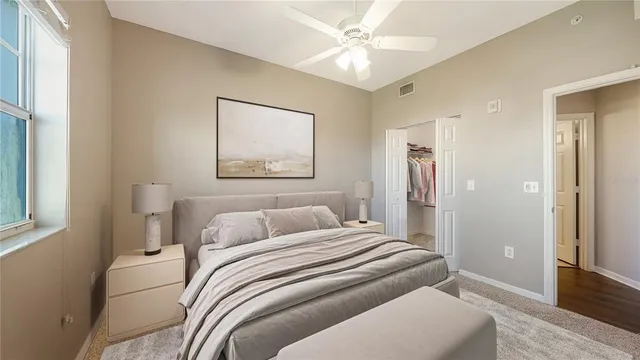 a bedroom with a large bed and a chandelier