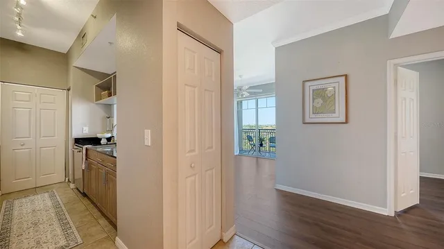 a view of a kitchen with wooden floor electronic appliances and windows