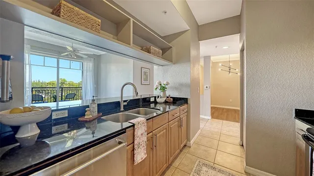 a kitchen with a sink and a stove top oven