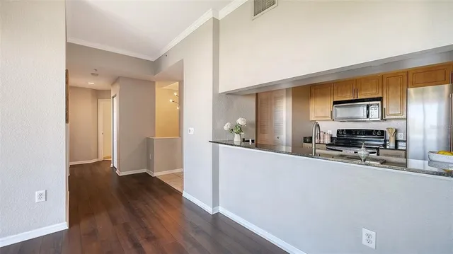 a view of a kitchen cabinets and wooden floor