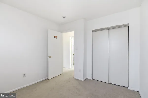 an empty room with closet area