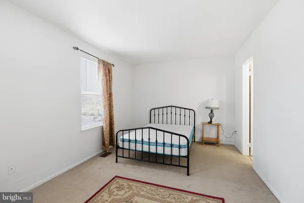 a view of a room with a baby crib and a window