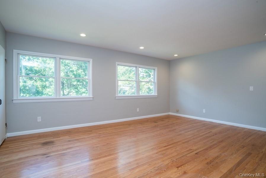 17 Vista Drive Great Neck, NY 11021 - Photo 11 of 20 Empty room with light wood-style flooring and recessed lighting