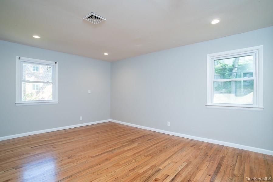 17 Vista Drive Great Neck, NY 11021 - Photo 14 of 20 Empty room with light wood finished floors and recessed lighting