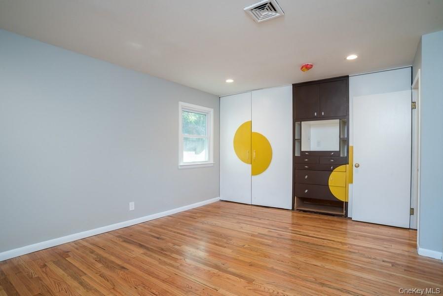 17 Vista Drive Great Neck, NY 11021 - Photo 15 of 20 Unfurnished bedroom with light wood-style floors and recessed lighting