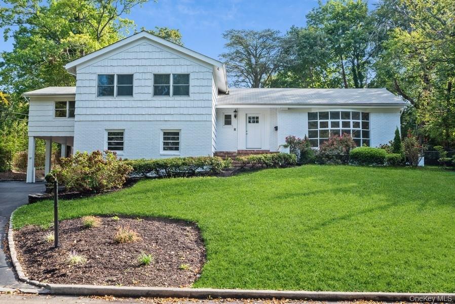 17 Vista Drive Great Neck, NY 11021 - Photo 20 of 20 Split level home with a front lawn, a carport, brick siding, and asphalt driveway