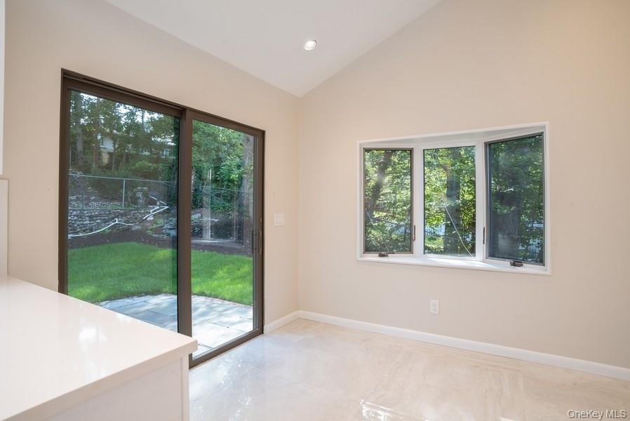 17 Vista Drive Great Neck, NY 11021 - Photo 5 of 20 Doorway with vaulted ceiling, plenty of natural light, and recessed lighting