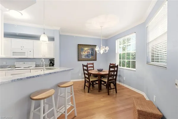 a view of a dining room with furniture and a window