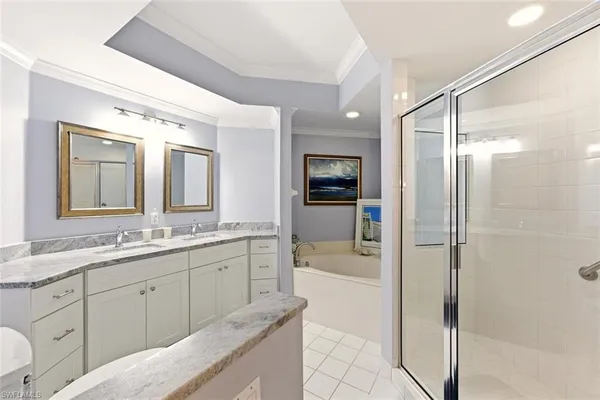 a bathroom with a granite countertop sink mirror and bathtub