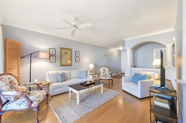 a living room with furniture and a lamp