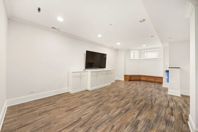 a view of a livingroom with wooden floor and flat screen tv