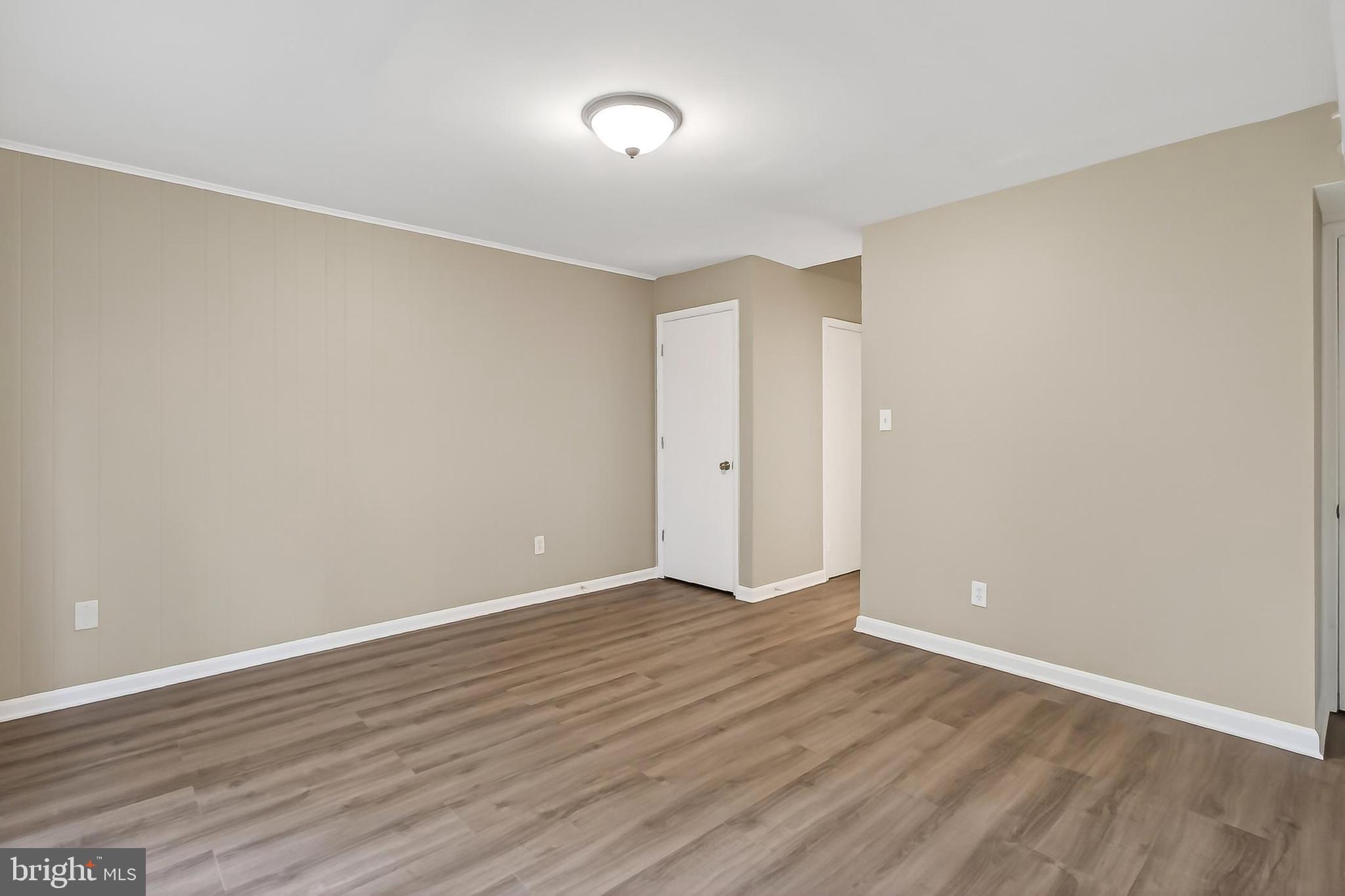 5833 Royal Ridge Drive, Unit 943 Springfield, VA 22152 - Photo 35 of 45 a view of an empty room with wooden floor