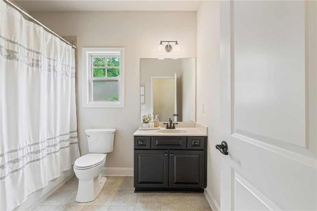 4735 Amble Trace Cumming, GA 30040 - Photo 49 of 73 a bathroom with a toilet sink and mirror