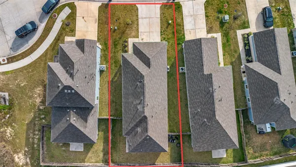 an aerial view of residential houses with outdoor space