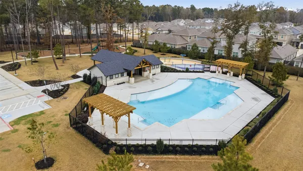 an aerial view of a house with swimming pool and patio