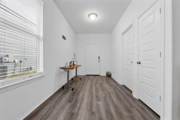 a view of a livingroom with wooden floor and a window