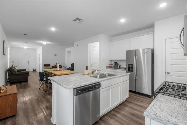 a kitchen with a sink stove and refrigerator