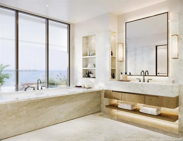 a bathroom with a tub a sink and a large mirror