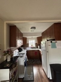 a kitchen with refrigerator and window