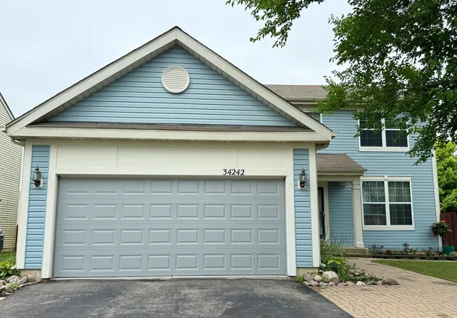 a front view of a house with garage