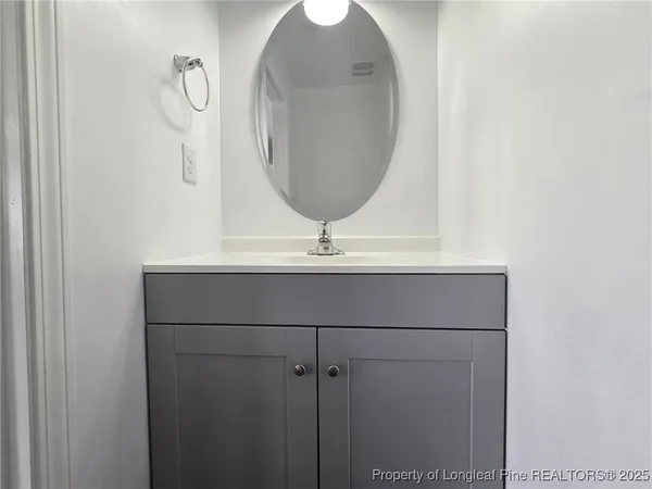 a bathroom with a sink and mirror