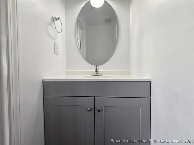 a bathroom with a sink and mirror