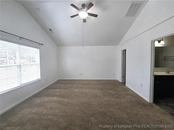 a view of a livingroom with a ceiling fan and window