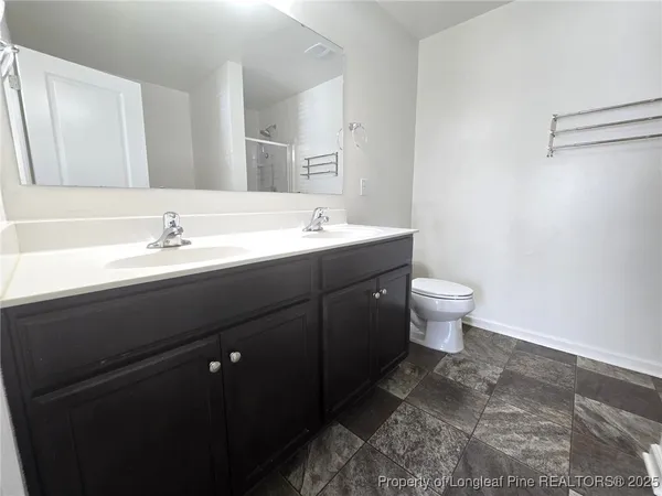 a bathroom with a sink toilet and mirror