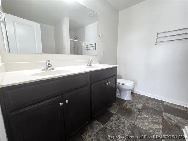 a bathroom with a sink toilet and mirror