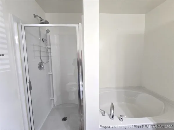 a bathroom with a glass shower door