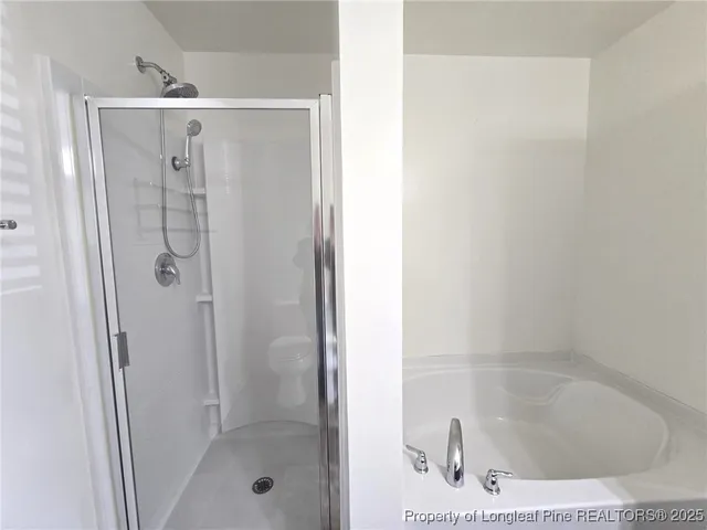 a bathroom with a glass shower door