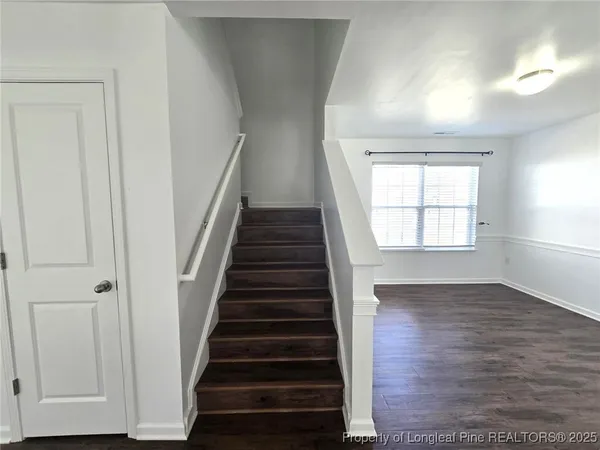 wooden floor in an empty room with stairs