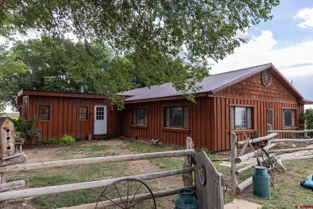 a front view of house with yard outdoor seating and barbeque oven