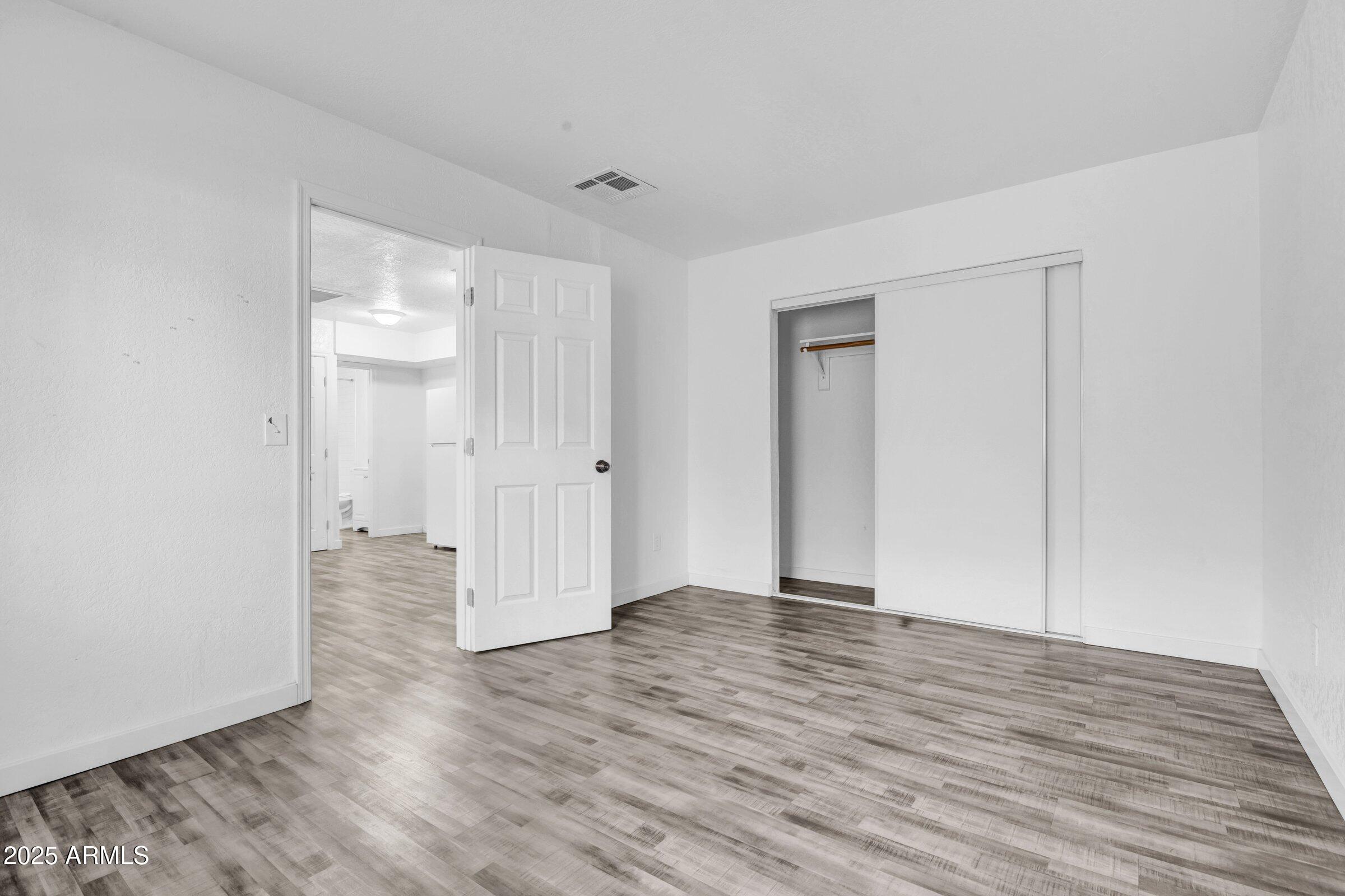 1123 West Fillmore Street Phoenix, AZ 85007 - Photo 12 of 20 a view of an empty room with wooden floor and closet