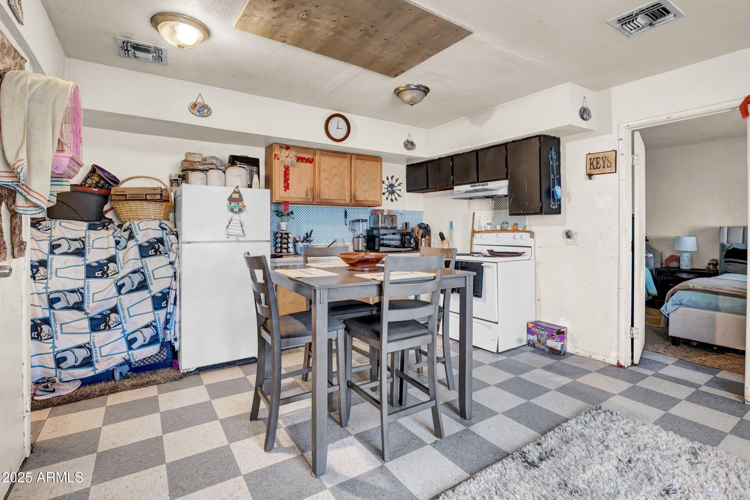 1123 West Fillmore Street Phoenix, AZ 85007 - Photo 15 of 20 a kitchen with stainless steel appliances kitchen island granite countertop a sink and a refrigerator