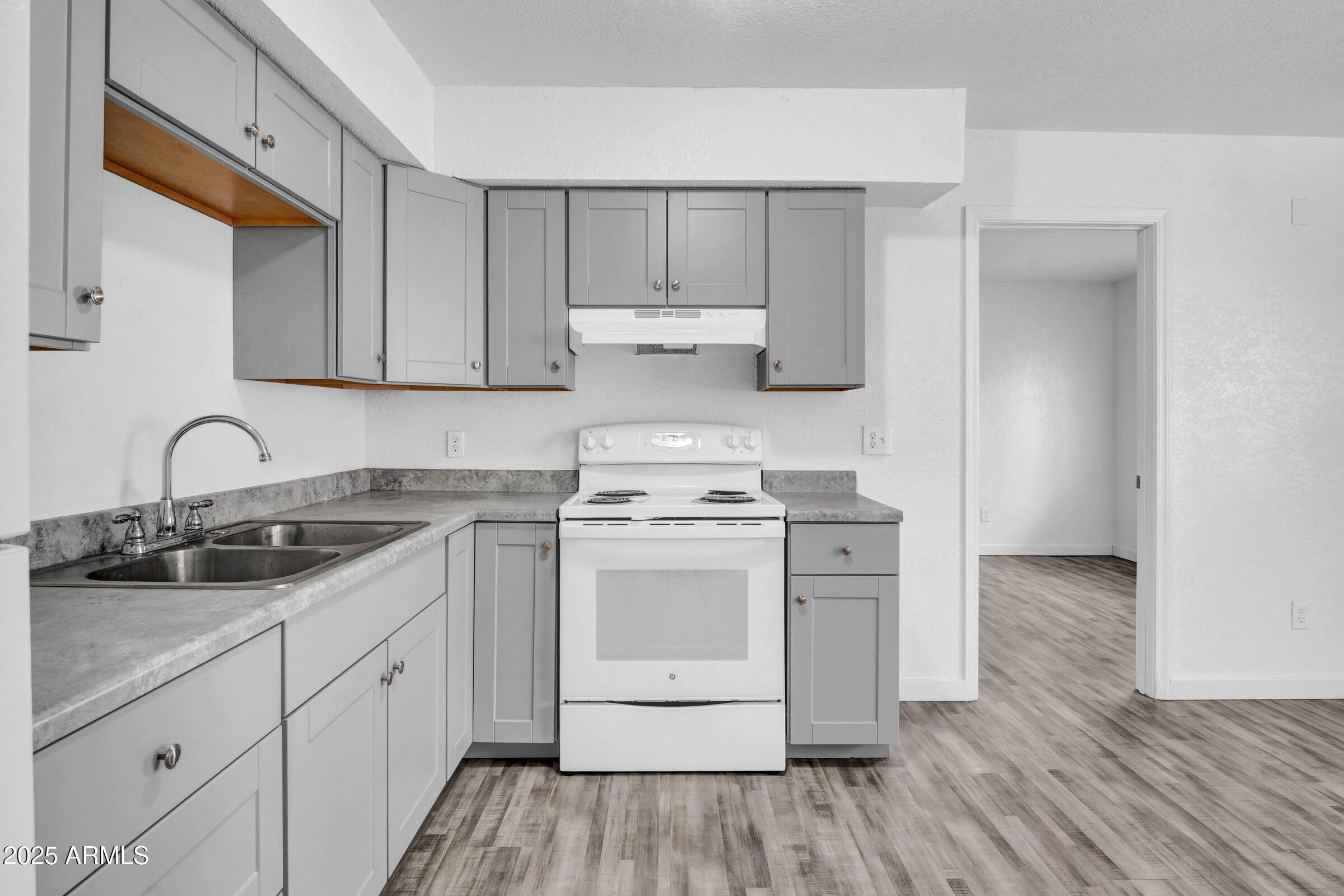 1123 West Fillmore Street Phoenix, AZ 85007 - Photo 9 of 20 a kitchen with a stove oven and sink