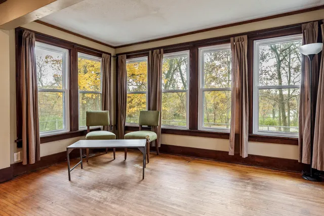 a living room with furniture and large windows